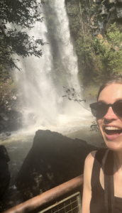 Girl in front of a waterfall in Parque Nacional Iguazú